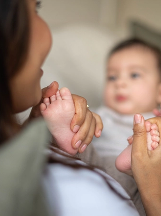 Mum rubbing baby's feet