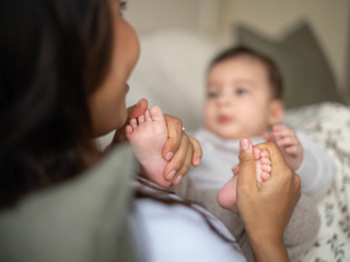 Mum rubbing baby's feet