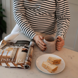 Pregnant woman eating a sandwhich