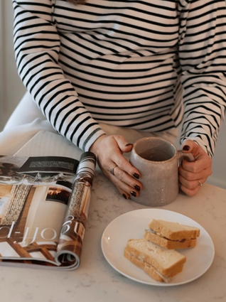 Pregnant woman eating a sandwhich
