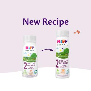 HiPP Organic follow on milk ready to feed bottles showing the old and new 6+ months recipe side by side on a soft pastel background