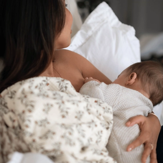 Mum breastfeeding baby in bed
