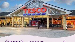 Promotional banner showing the storefront of a Tesco supermarket with a text overlay that reads: "WIN a £300 Tesco voucher".