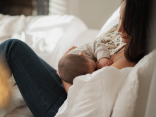 Mum breastfeeding baby in bed