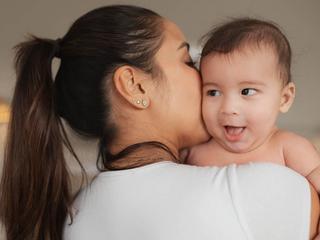 Mum kissing baby's cheek