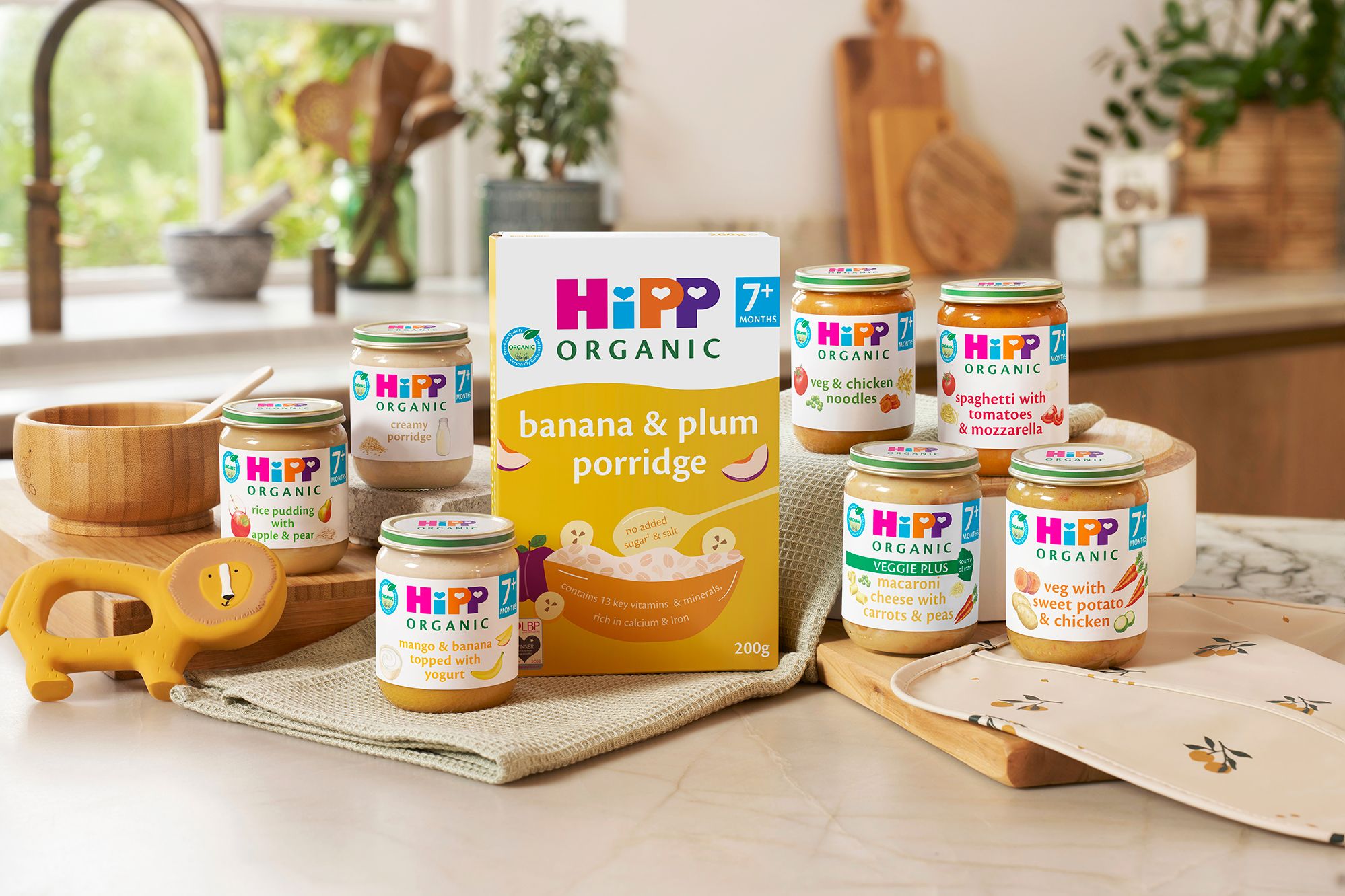 HiPP Organic baby food jars and banana and plum porridge displayed in a family kitchen