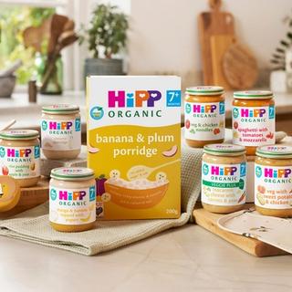 HiPP Organic baby food jars and banana and plum porridge displayed in a family kitchen