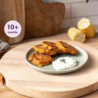 Tuna and sweetcorn fritters on a small plate with a dollop of dip, suitable as finger food for babies 10 months and over