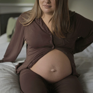 Pregnant woman holding back