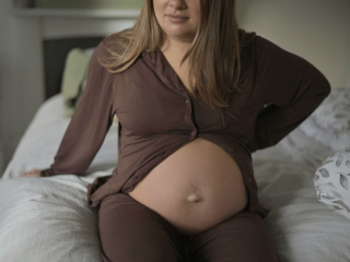 Pregnant woman holding back