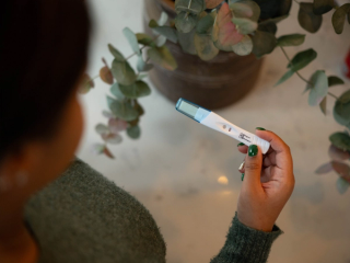 Woman holding positive pregnancy test