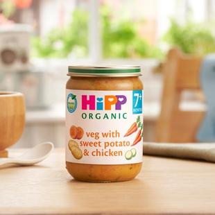 HiPP Organic Veg With Sweet Potato & Chicken Jar on a dining table next to a bowl and spoon