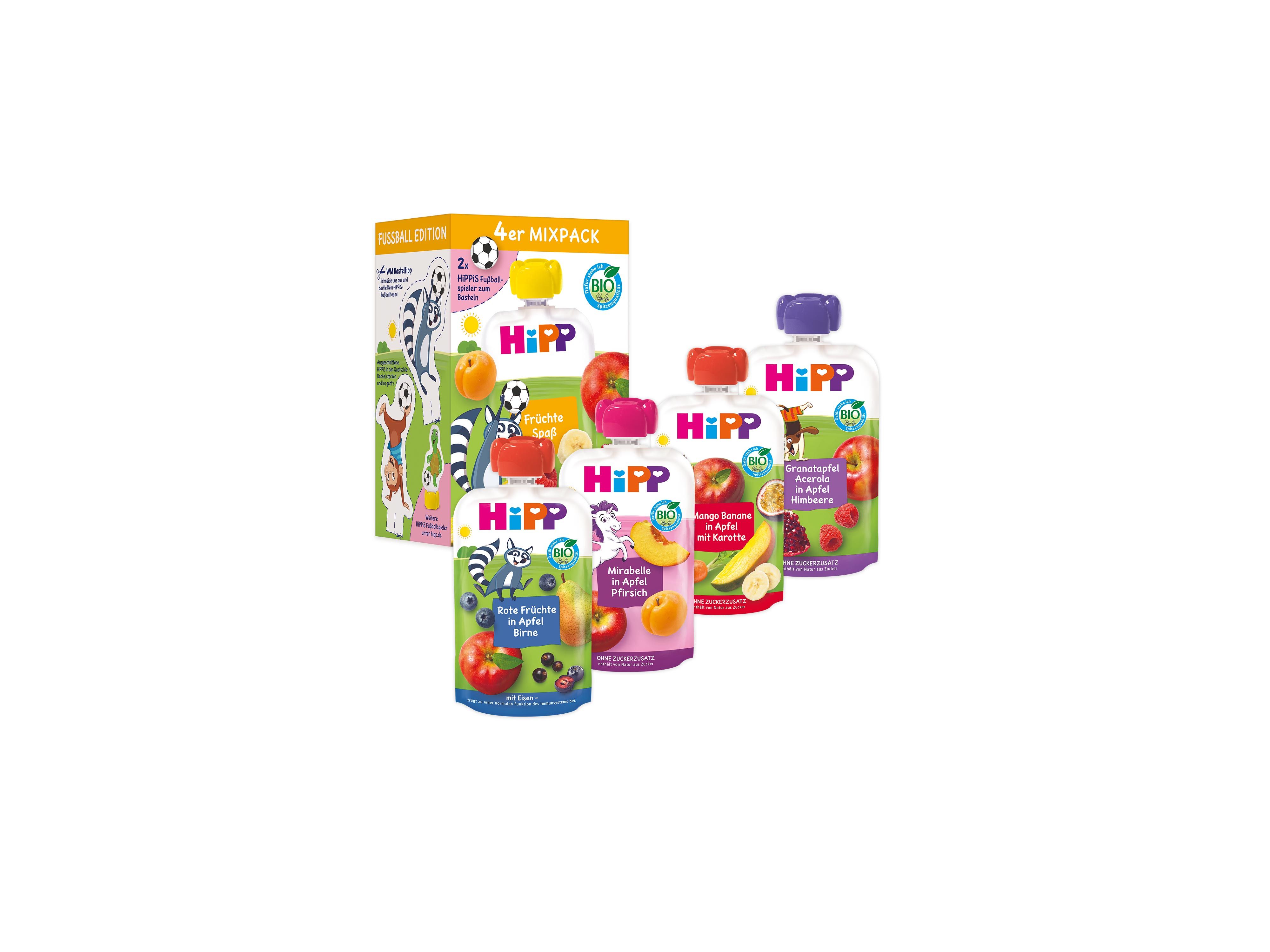 Mehrere bunte Hipp Babybrei-Quetschbeutel vor einer Verpackung mit Tierillustrationen