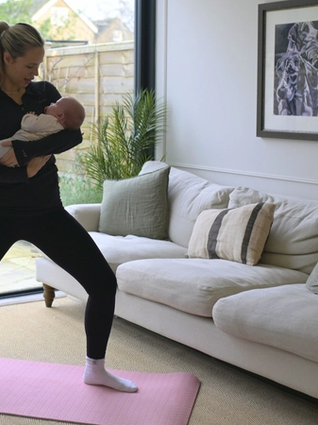 Mum doing gentle stretches whilst holding baby