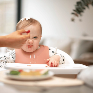 Baby scowling at raspberry