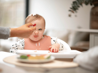Baby scowling at raspberry