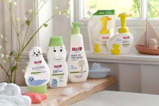 HiPP Baby Care range of products on a shelf over a bath and on a window sill