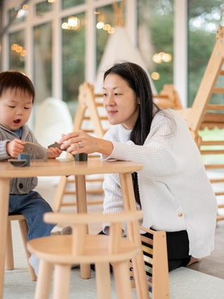 Mum and son playing at toddler table
