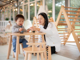 Mum and son playing at toddler table