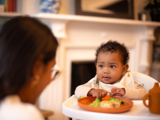 Mum feeding baby in highchair
