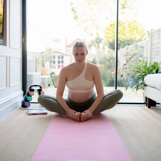 Pregnant woman doing yoga strech