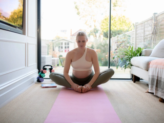 Pregnant woman doing yoga strech