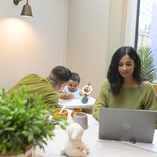 Mum working whilst dad entertains child