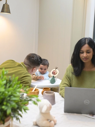 Mum working whilst dad entertains child