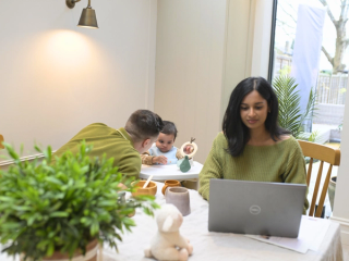 Mum working whilst dad entertains child