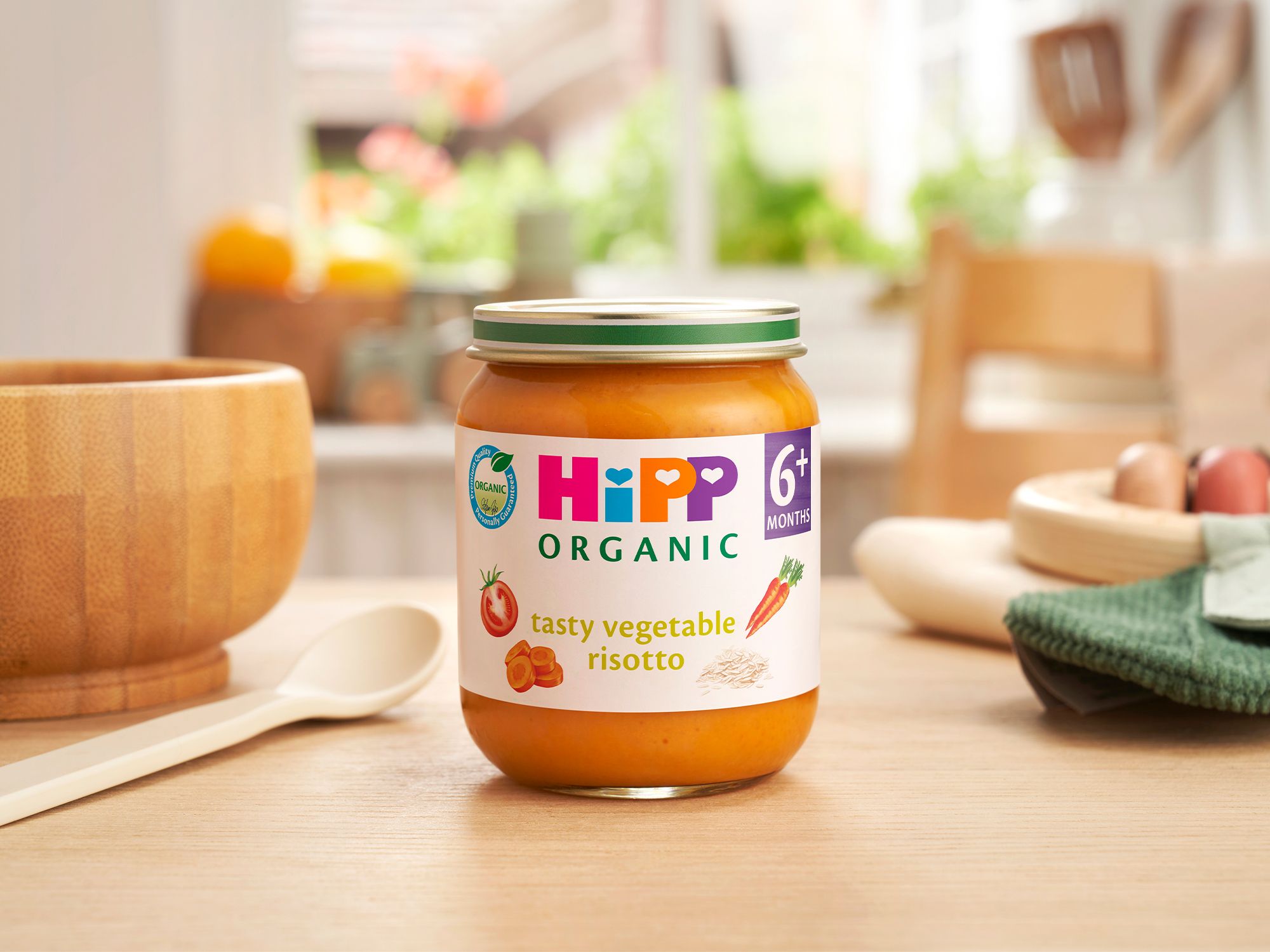 HiPP Organic Tasty Vegetable Risotto on a dining table next to a bowl and spoon