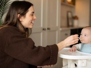 Mum spoon feeding son