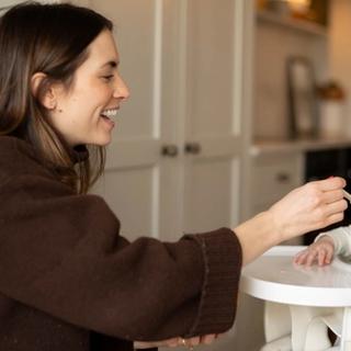 Mum spoon feeding son