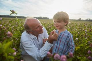 Stefan with his son in a field of wild flowers