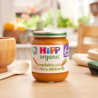 HiPP Organic Vegetables with Rice And Chicken on a dining table next to a bowl and spoon