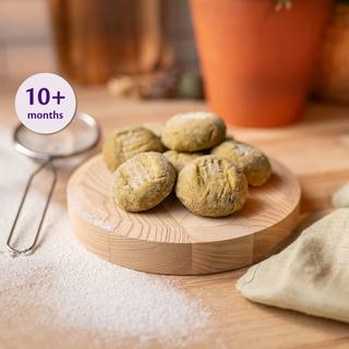 Soft baked falafel bites on a wooden board with a 10+ months label, ready as a baby-friendly finger food.