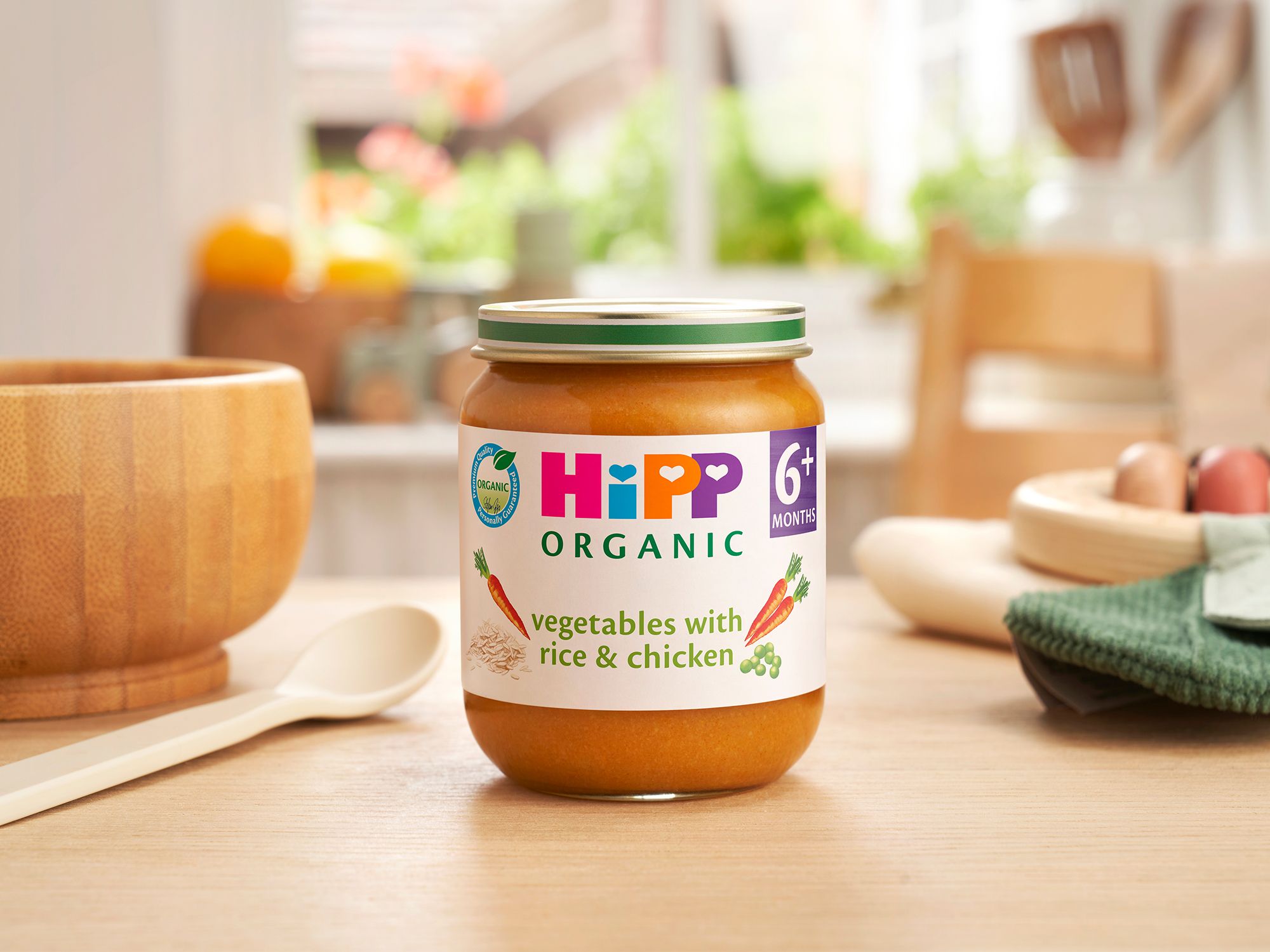 HiPP Organic Vegetables with Rice And Chicken on a dining table next to a bowl and spoon