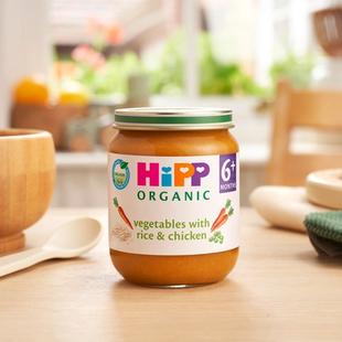 HiPP Organic Vegetables with Rice And Chicken on a dining table next to a bowl and spoon