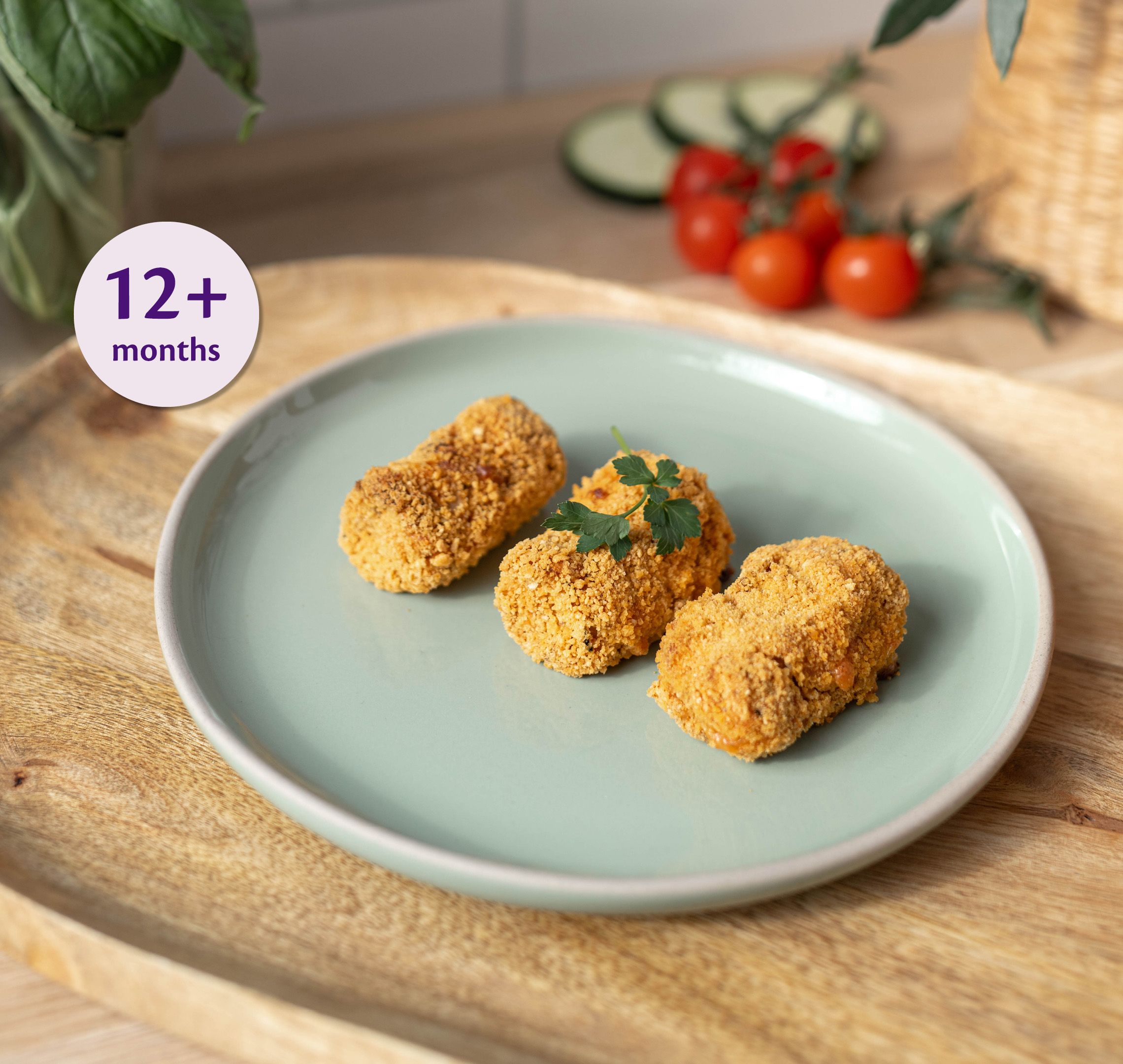 Three golden cheesy lasagne croquettes on a pastel plate, labelled suitable for babies 12+ months