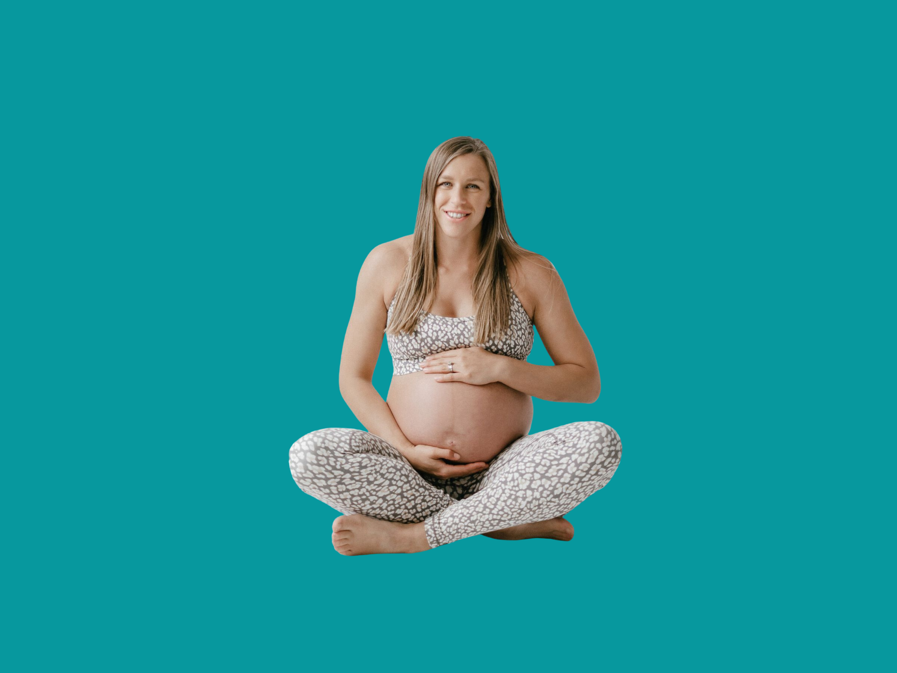 Pregnant woman sat crossed leg holding bump