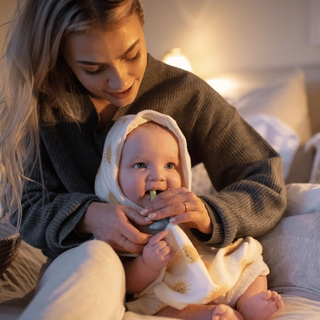 Mum brushing her baby’s teeth