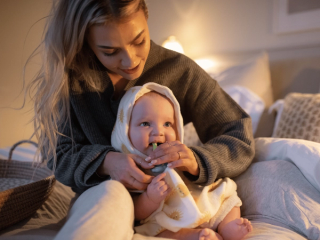 Mum brushing her baby’s teeth