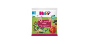 HiPP Bio Urkorn Dinos Snackpack mit Dinofiguren, Cranberry- und Johannisbeeren-Motiv sowie Urgetreide und Apfel auf der Vorderseite