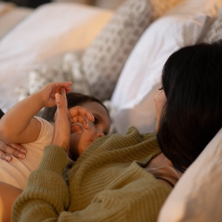 Mum breastfeeding baby in bed