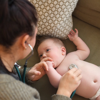 Baby with stethoscope on chest