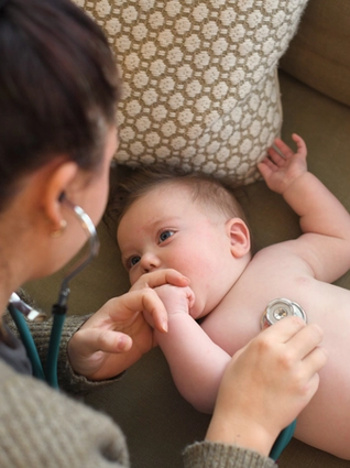 Baby with stethoscope on chest
