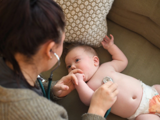 Baby with stethoscope on chest
