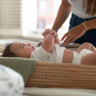 Mum changing baby on changing mat