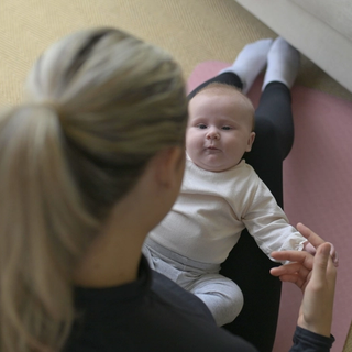 Mum sat with newborn on her lap