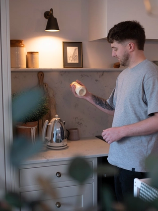 Dad preparing a bottle of follow on milk