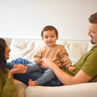 Mum and dad on sofa with baby